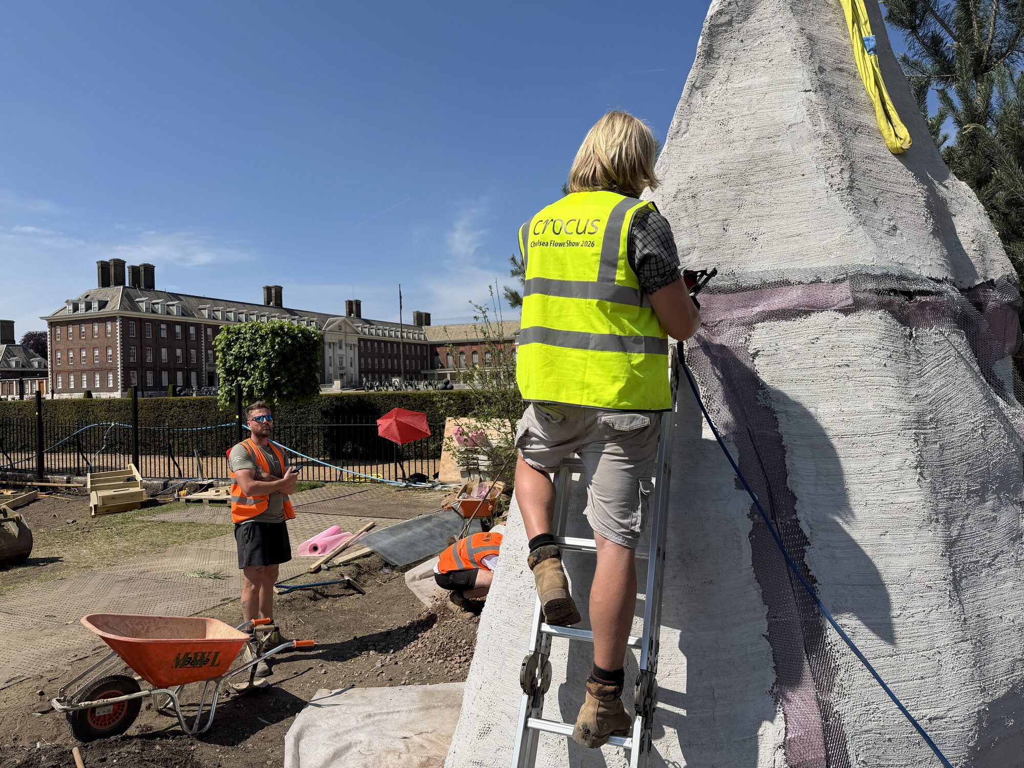 Render being applied to the ochre wall structure on site at Chelsea
