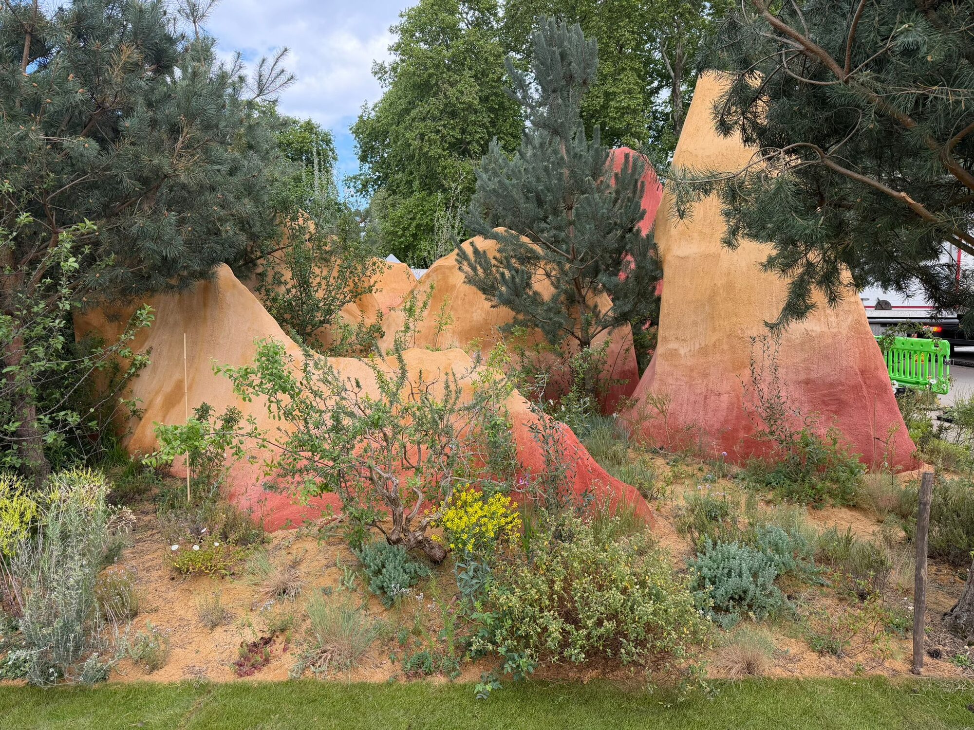 Towering ochre and red sandstone forms rising above pine woodland at Chelsea Flower Show 2026