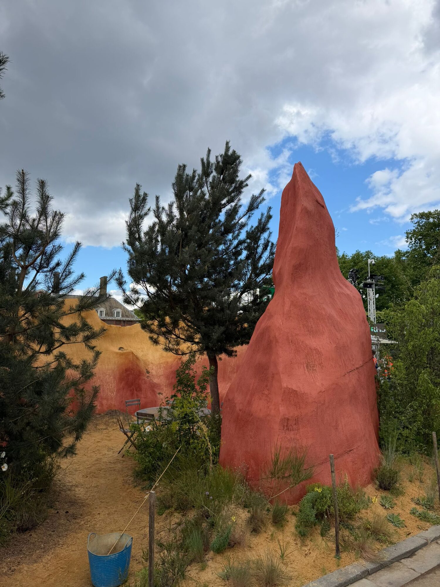 Red ochre cliff form with pine tree in the foreground