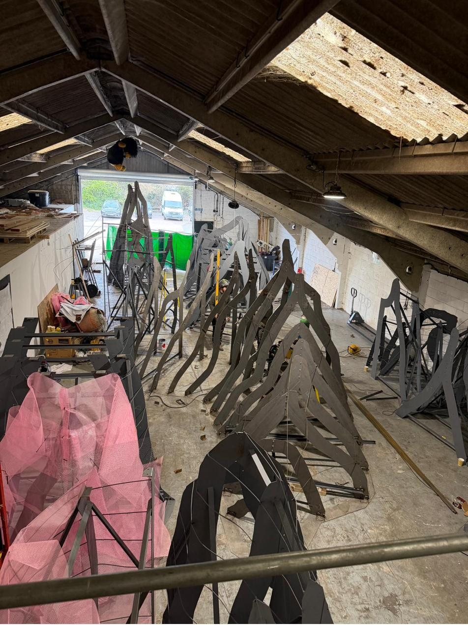 High wide view of all the rib frames filling the length of the workshop