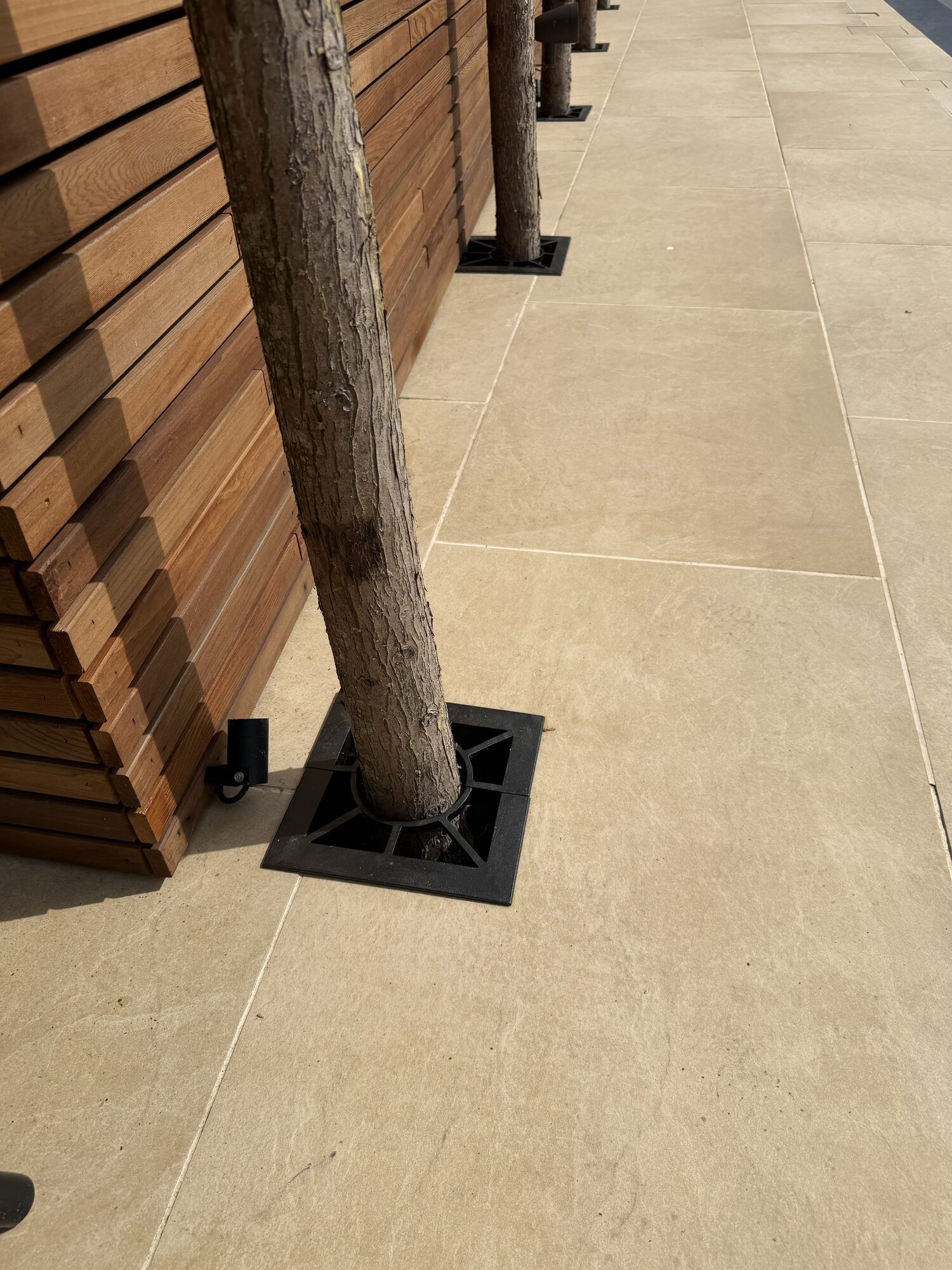 Automated sliding driveway gate with brick pillars and stone caps