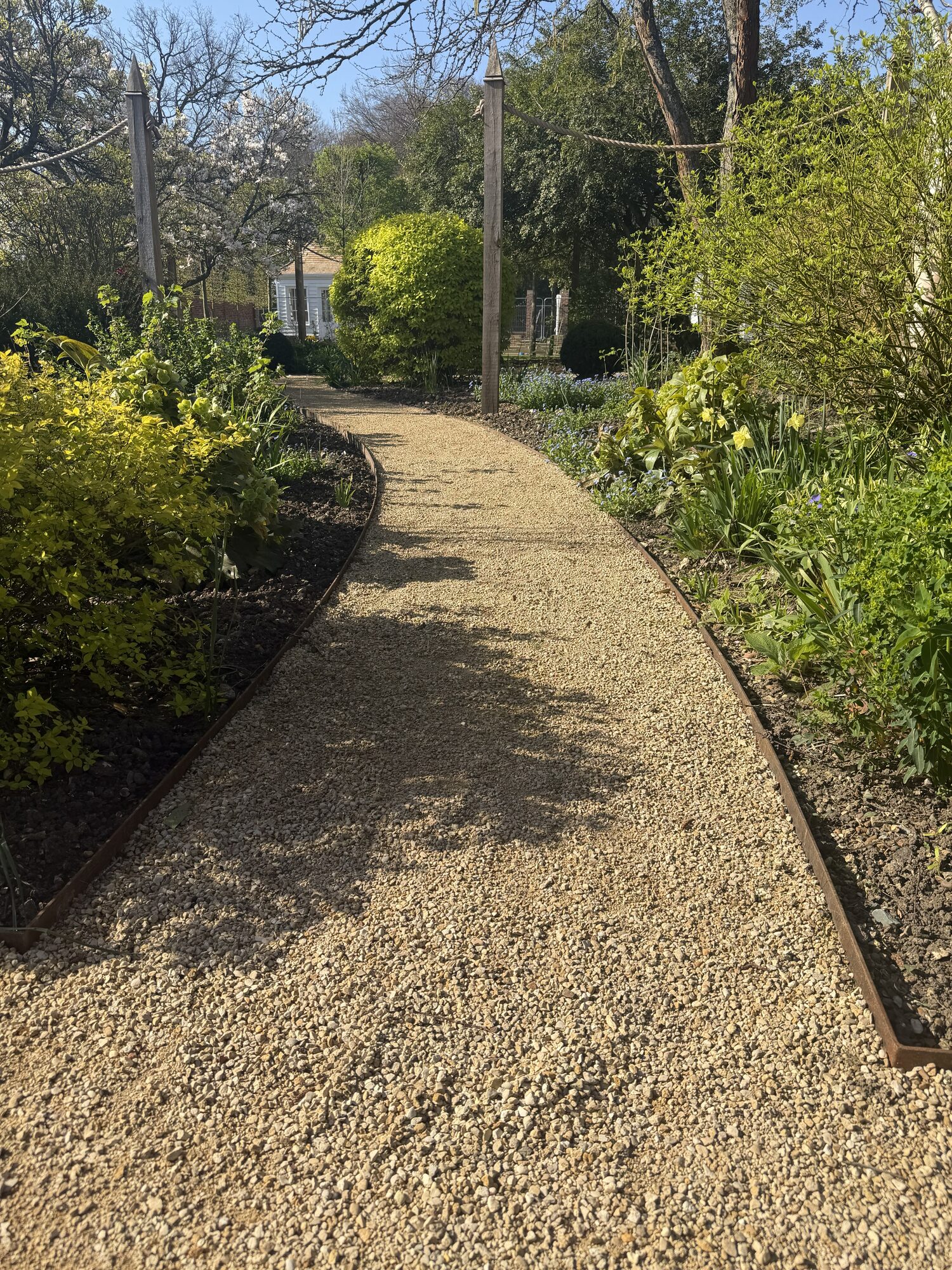 Grand spear-topped railings overlooking a manicured garden