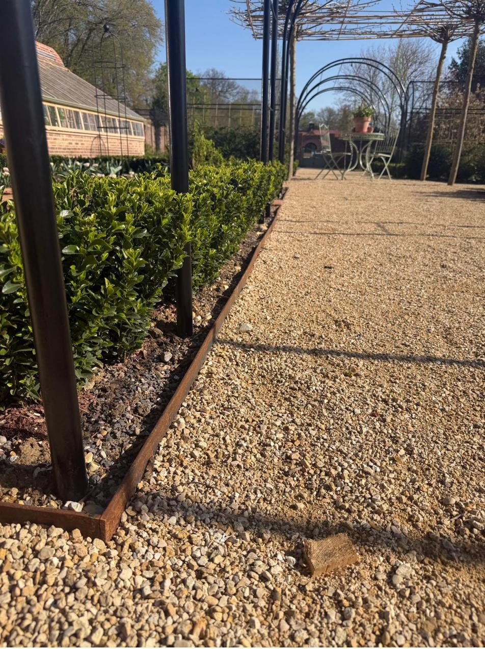 Steel pergola archway walkway with corten edging